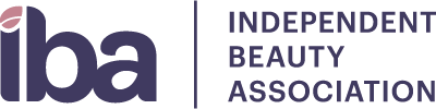 Logo of the Independent Beauty Association (IBA) featuring stylized text and a leaf icon, representing the organization’s focus on beauty industry advocacy.
